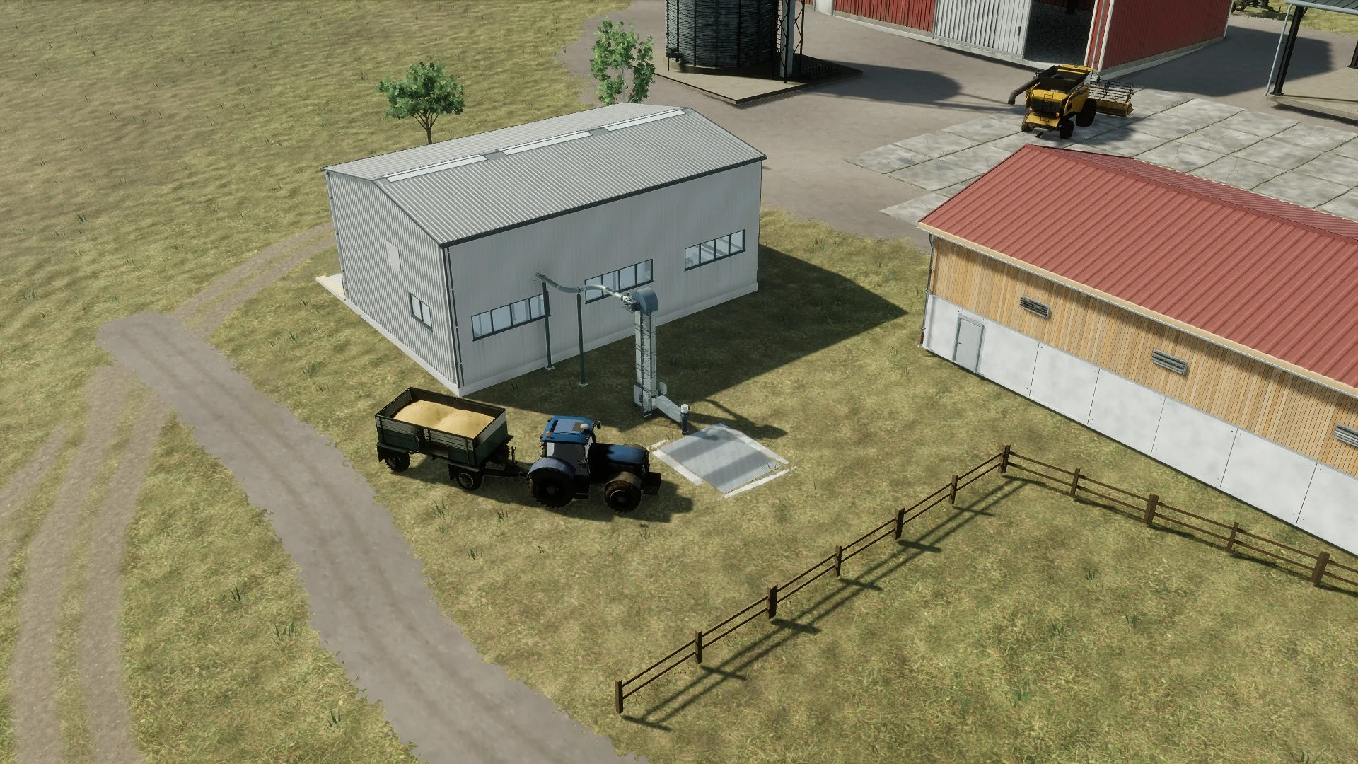 Traktor s vozem plným zrna přijíždí před mlýn k venkovnímu příjmu obilí.